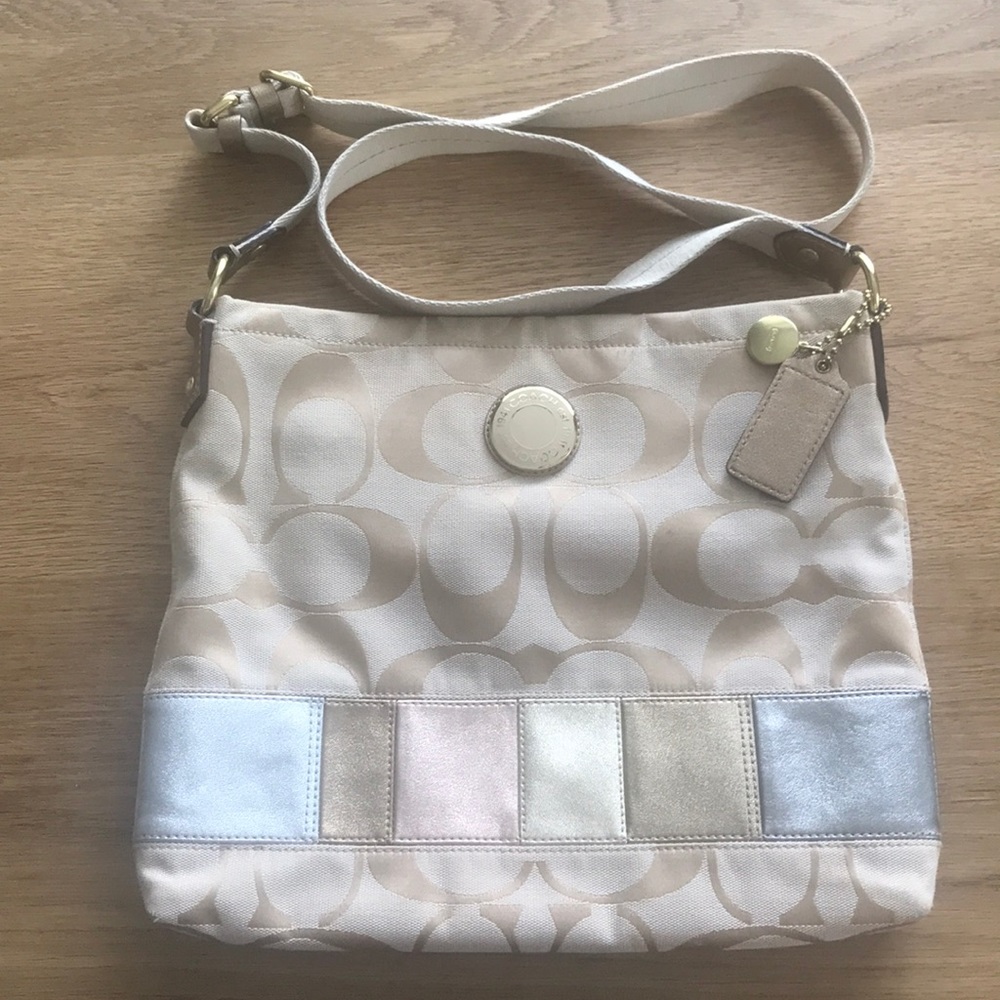 Coach khaki colored cross body purse.
